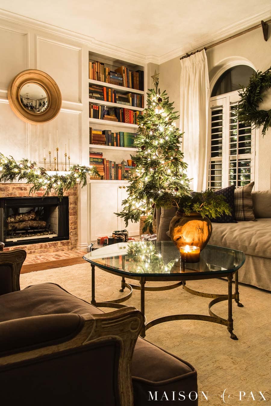 Christmas tree by fireplace with candlelight