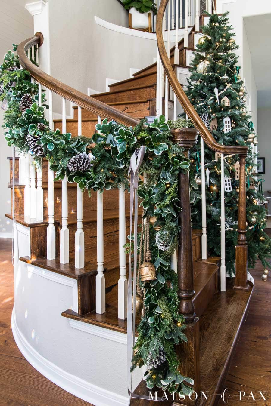 stairwell garland and tree in curved staircase