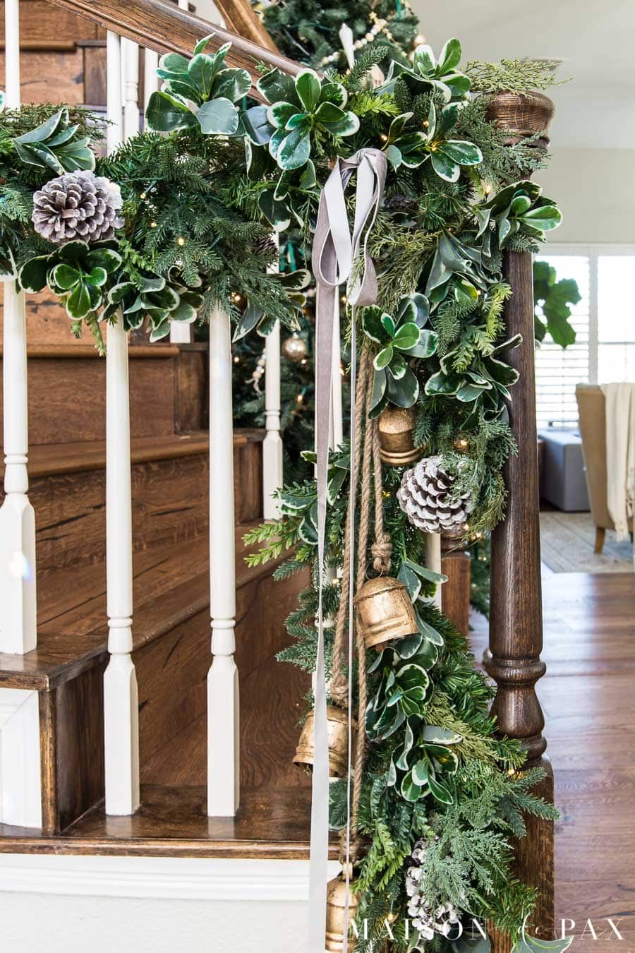 stairwell garland with pine cones and velvet ribbon
