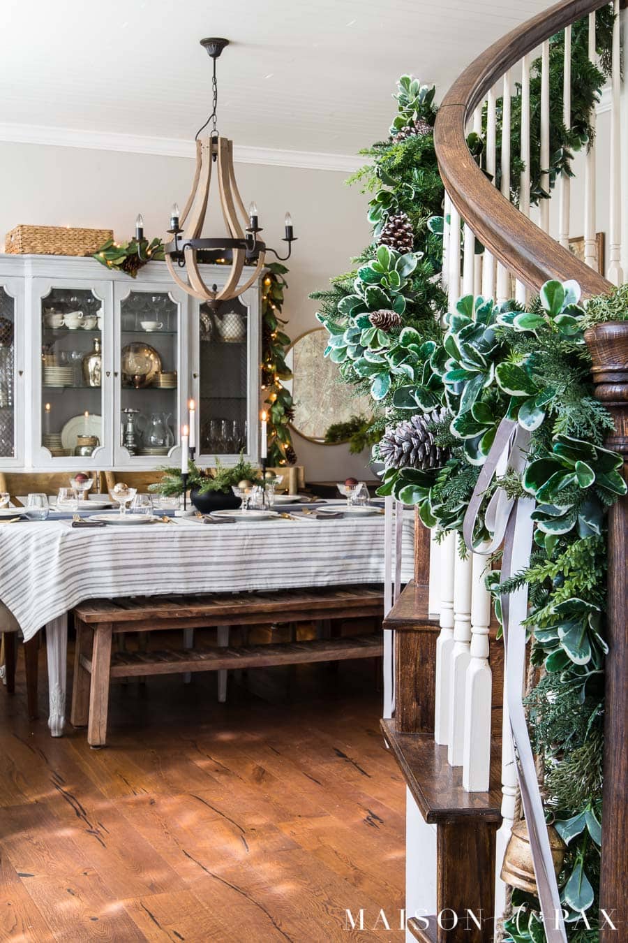 stairwell garland and a decorated holiday dining table