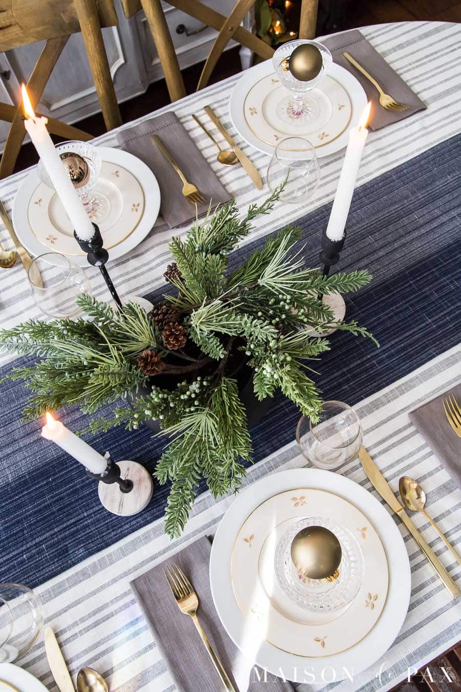 holiday dining table with blue runner and striped tablecloth