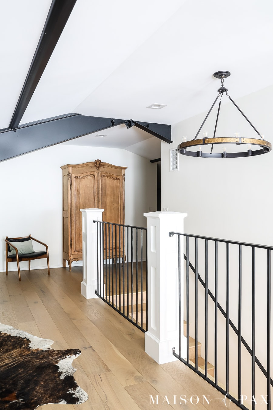 attic renovation: white walls, exposed black beams