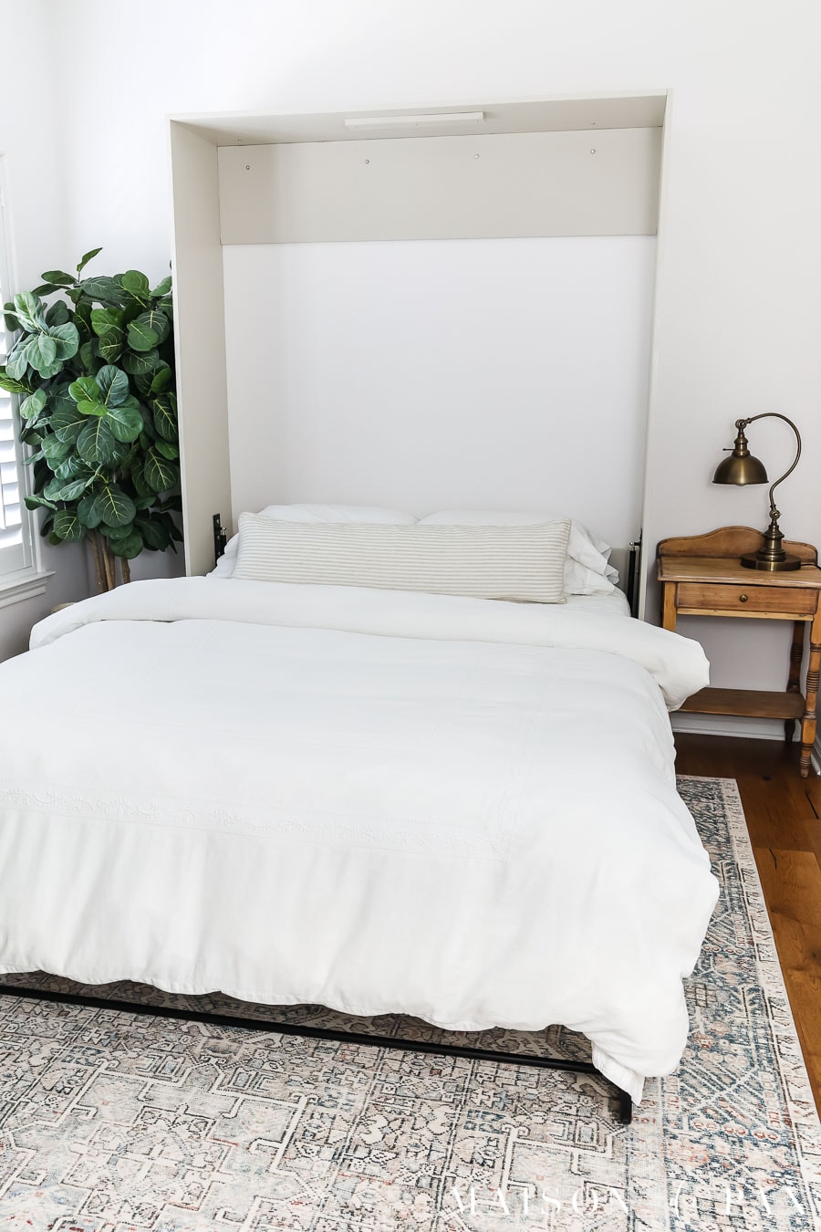 queen sized murphy bed open in small space