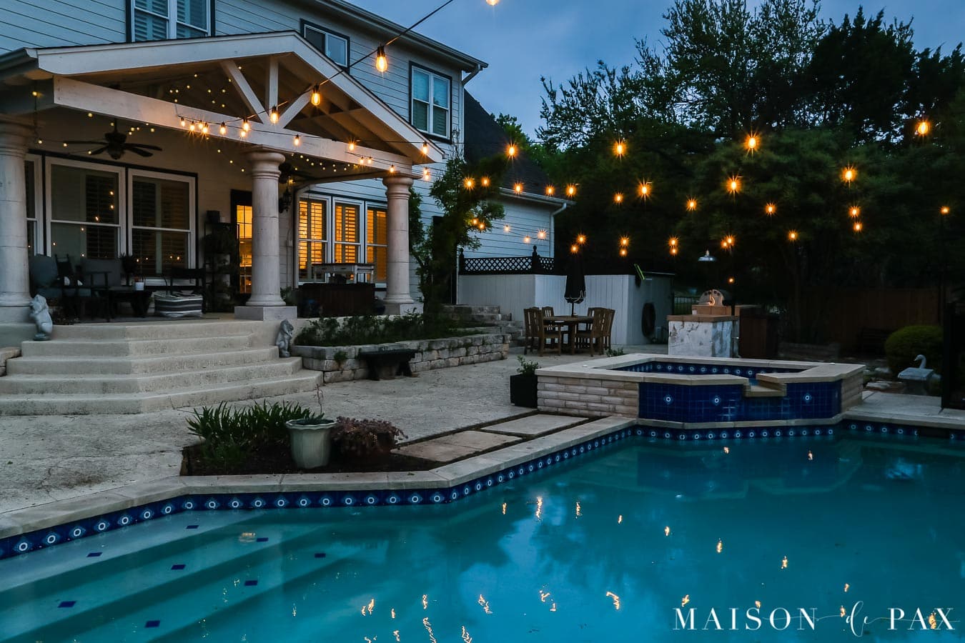edison bulb outdoor string lights over pool