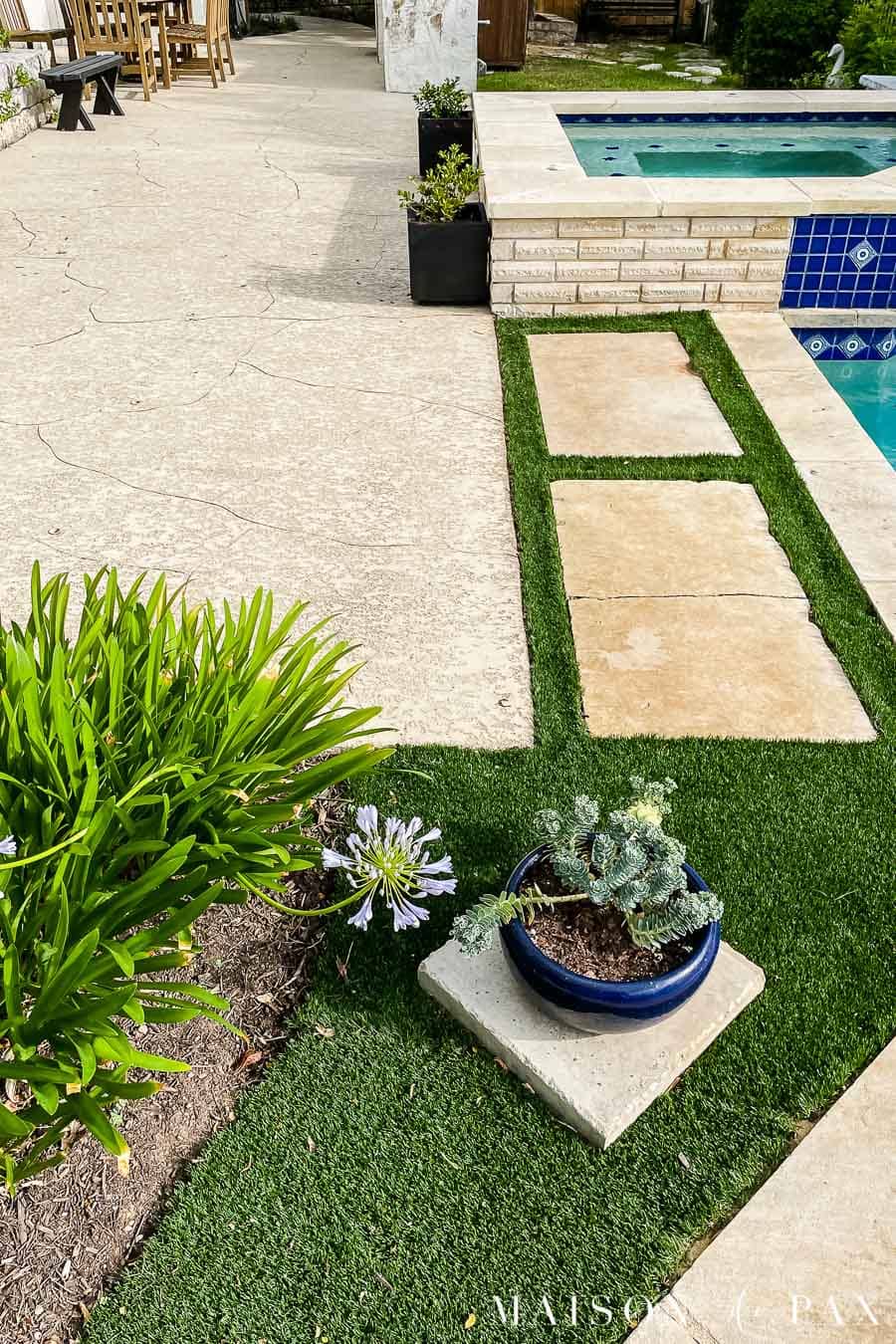 artificial turf with stepping stones beside pool