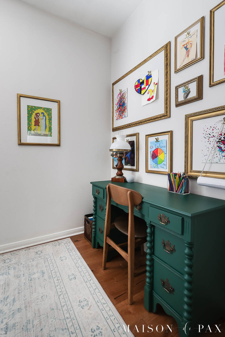 corner with gold frames gallery wall and dark green desk