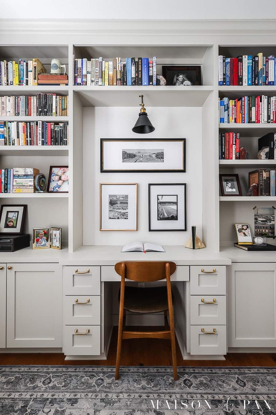 built in bookcases in home office with brass knobs and lots of books