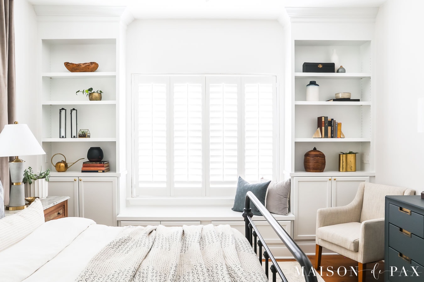 white built-in bookcases and window bench in bedroom