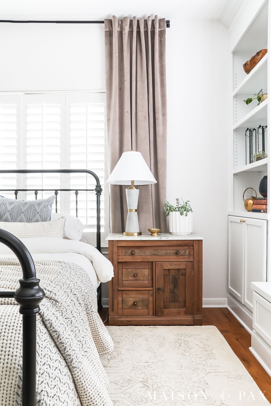 master bedroom with antique nightstand and modern table lamp