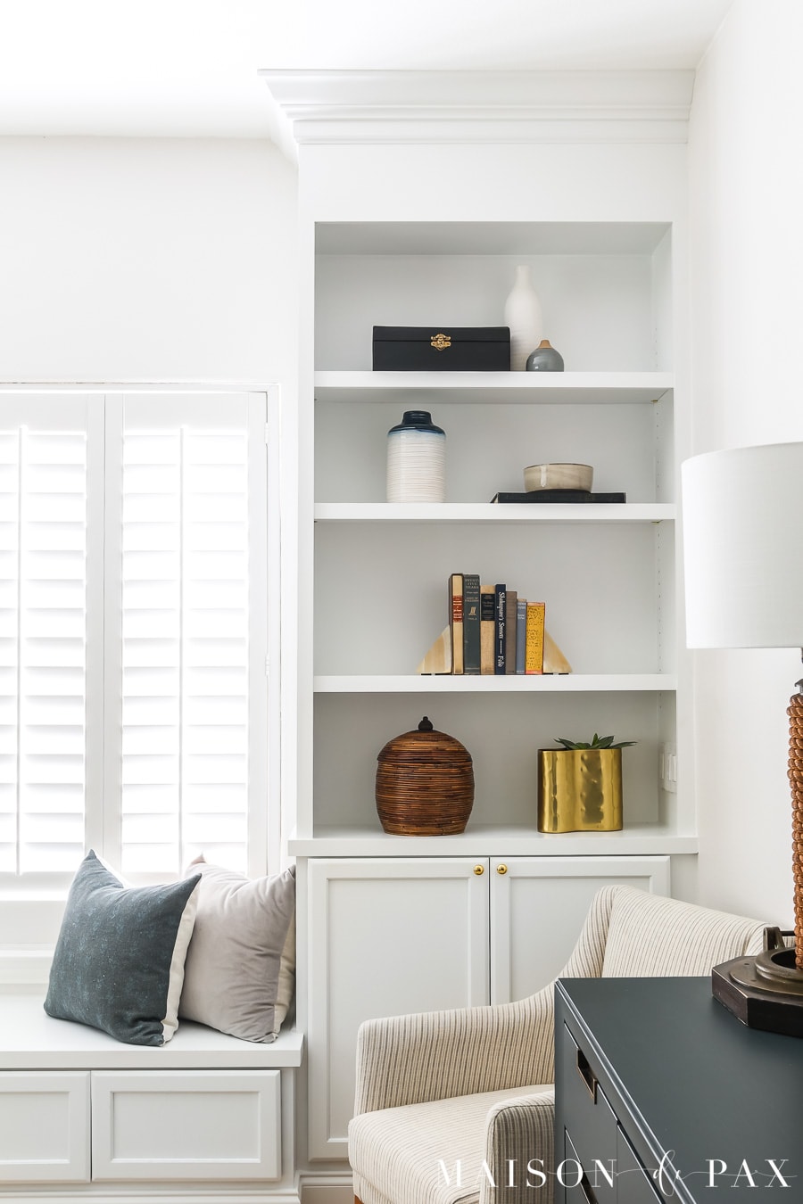 white built-in bookcase with simple decorative items