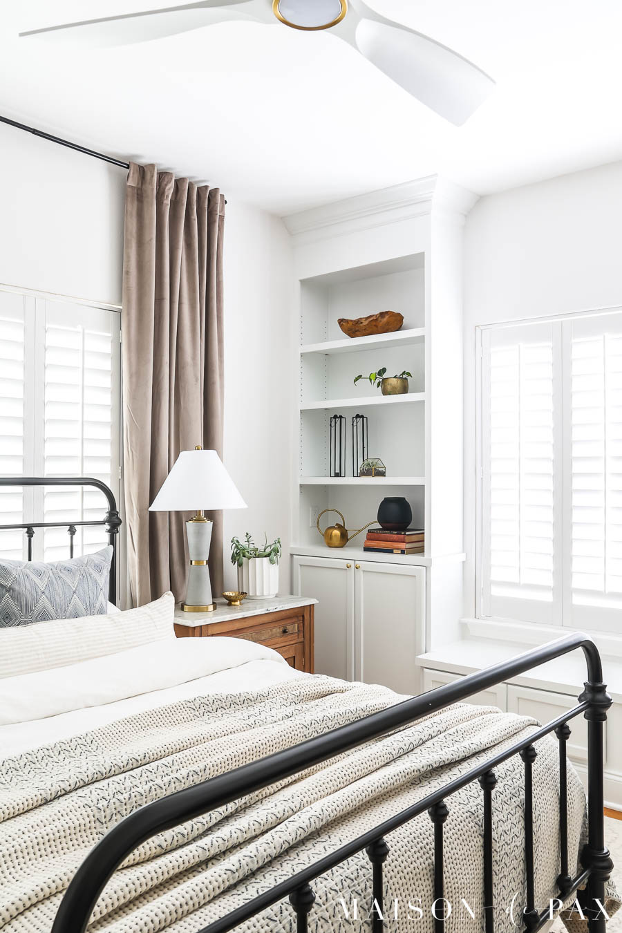 white built-in bookcases and window bench in bedroom