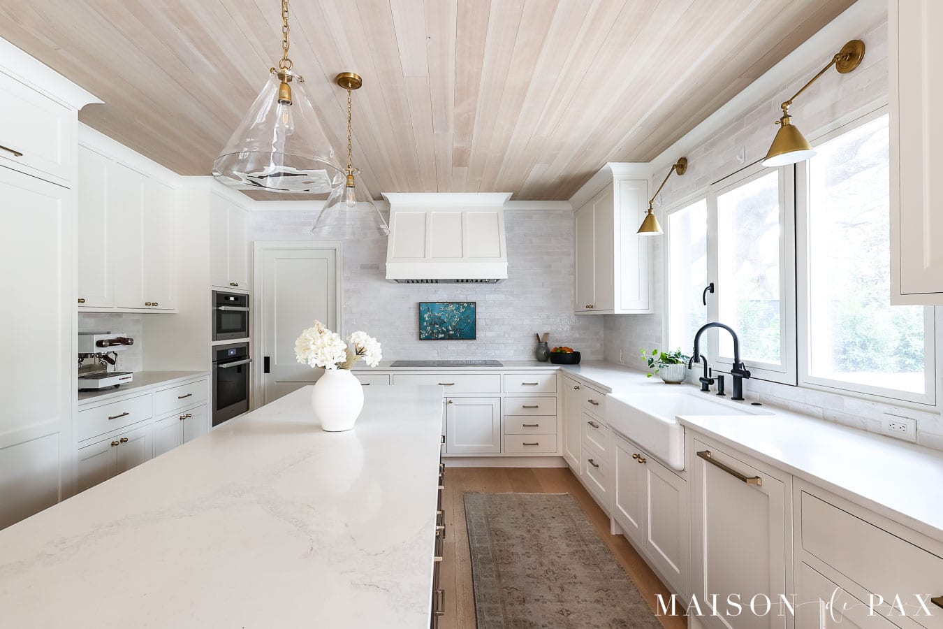 white cabinets, white backsplash, and white quartz countertops