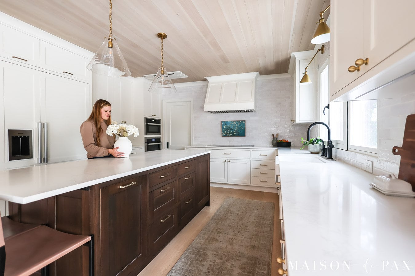 woman placing flowers on kitchen island with quartz countertops