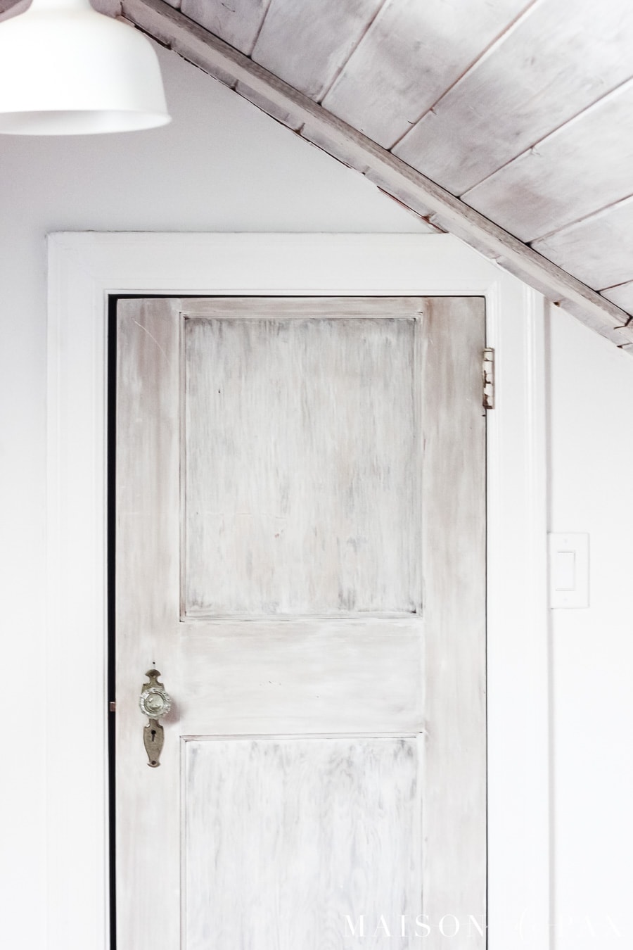 whitewashed door in converted attic nook