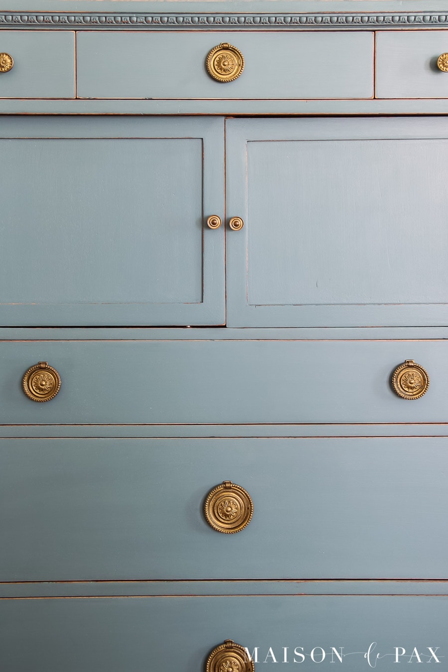 antique wood dresser painted a gray blue with brass hardware
