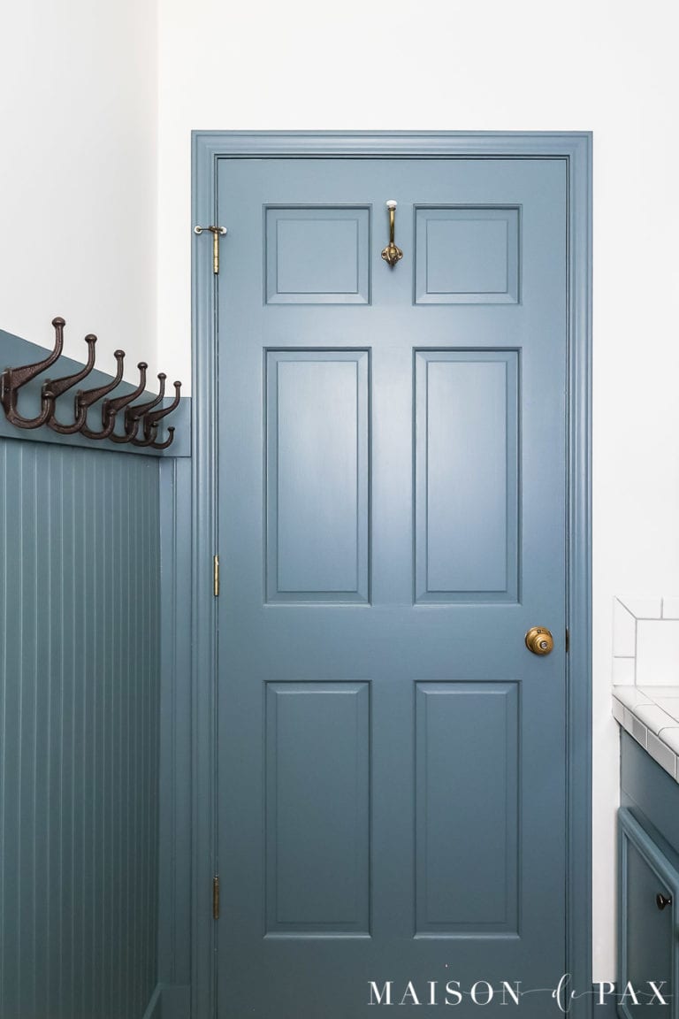 gray blue six panel door beside beadboard paneling