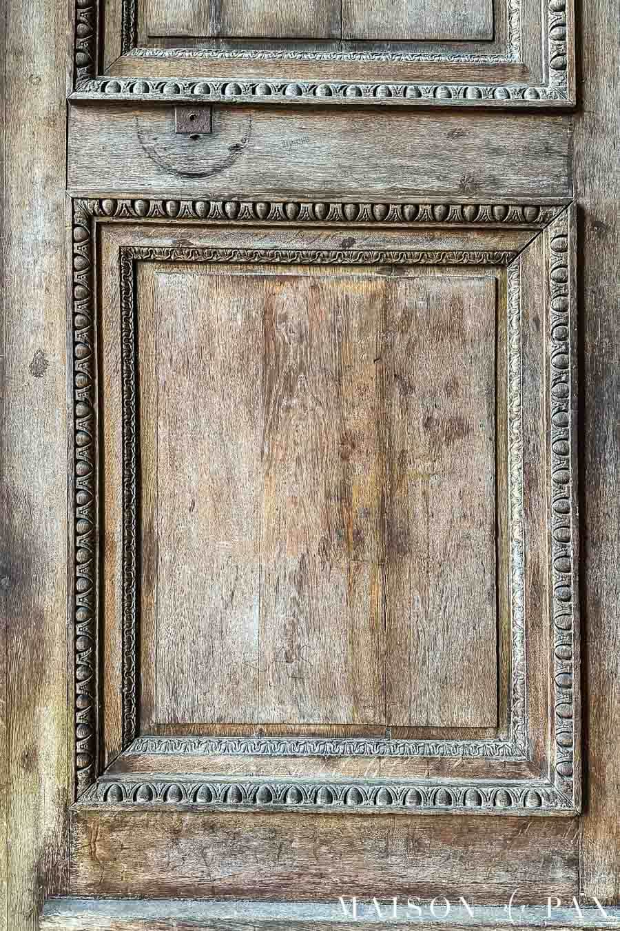 aged wood door with decorative trim