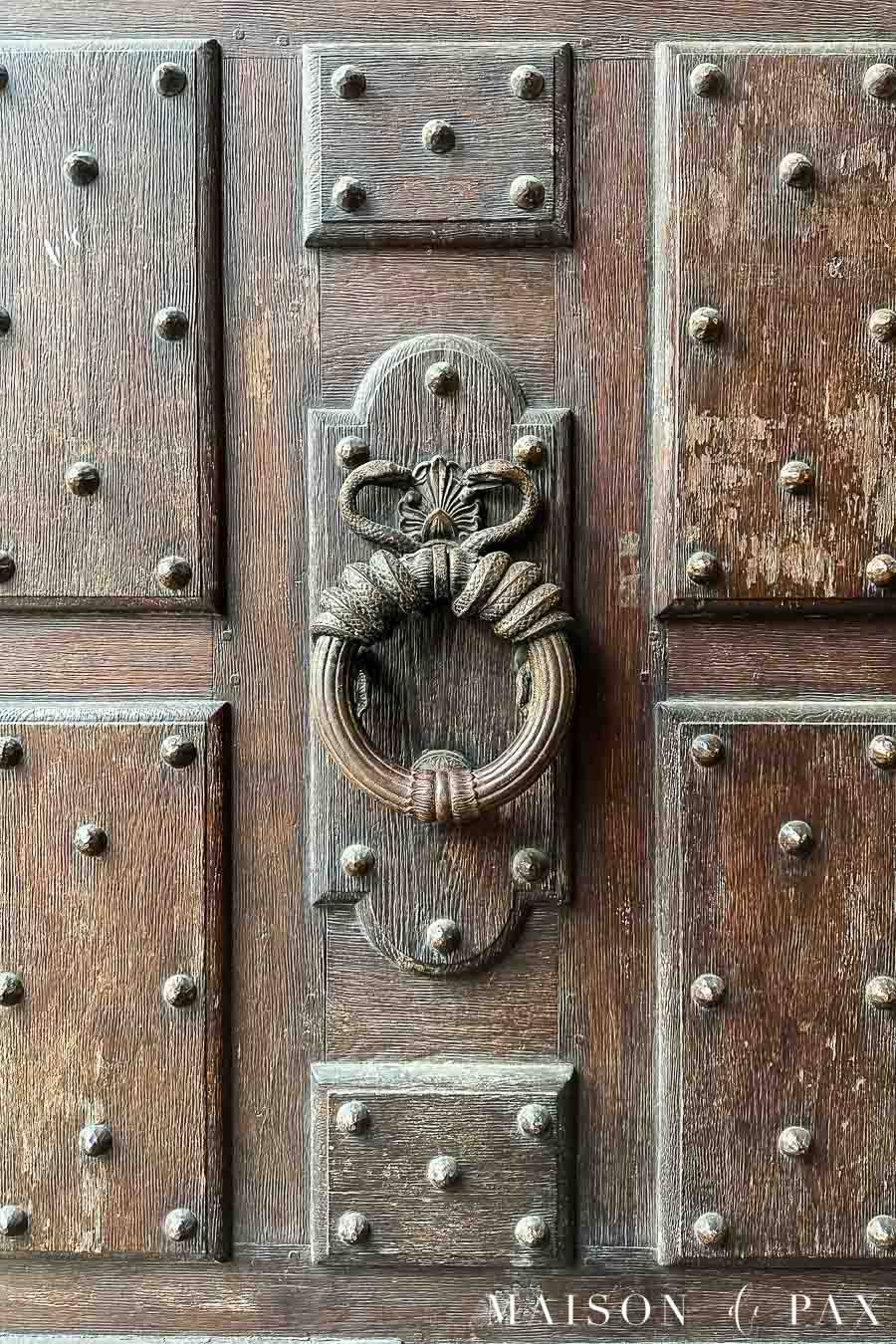 aged wood door with large knocker