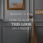image of gray blue bathroom with picture frame molding and text overlay: how to achieve this look on a budget