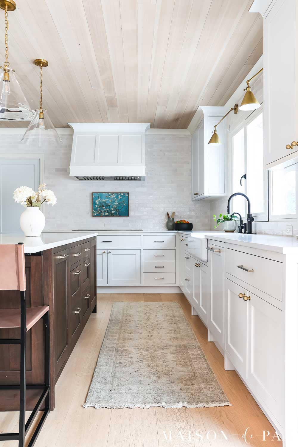 Sherwin Williams Pure White kitchen cabinets with white oak ceiling and dark wood island