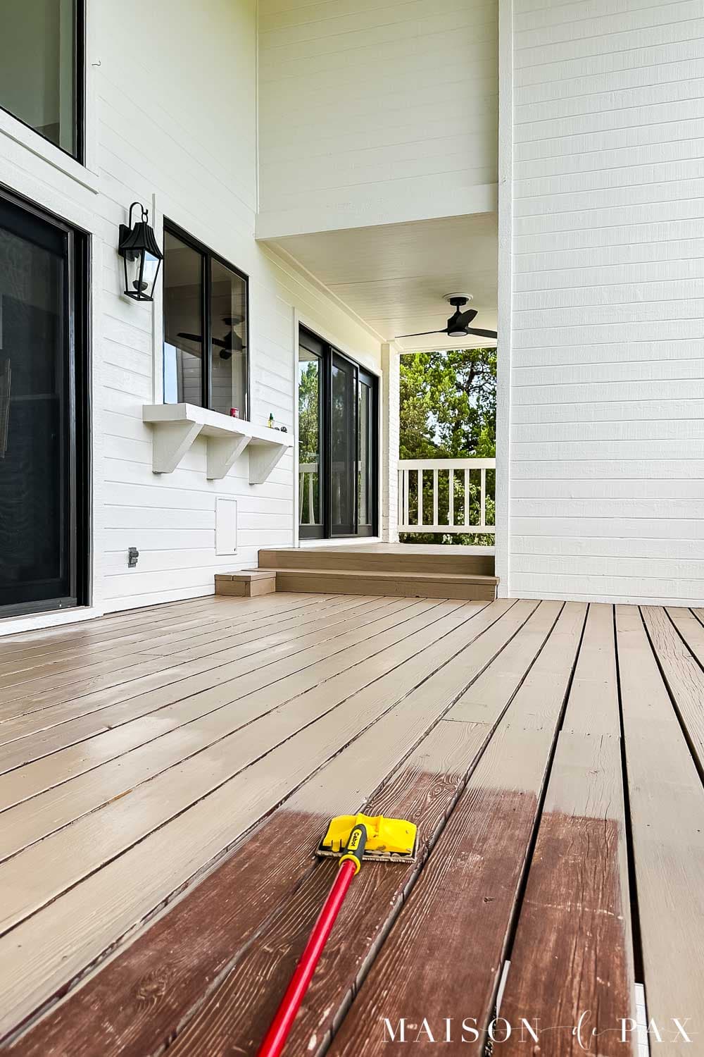 Solid deck stain in Cabot Acorn being applied with a stain pad beside the old reddish-brown finish, showing the dramatic color change.